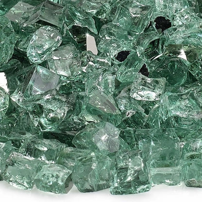 Close-up macro image of 1/2 inch premium reflective evergreen green tempered fire glass by American Fire Products, showing the subtle green tint, smooth polished surfaces, sharp angular fragments, and mirrored coating that intensifies light and flame sparkle.