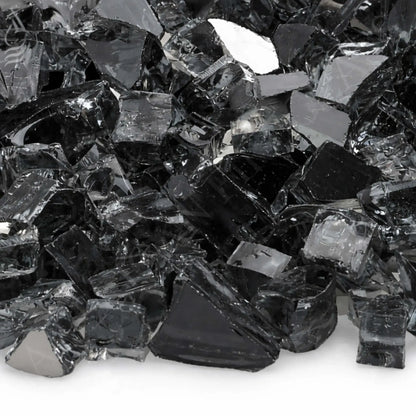 Tight close-up of American Fire Products 1/2 inch premium reflective gray fire glass, showcasing smoky translucent tempered pieces with angular cuts, polished edges, and a mirrored backing that catches light and adds depth to gas fire pit installations.