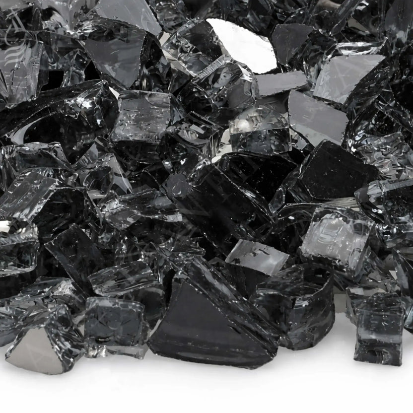 Tight close-up of American Fire Products 1/2 inch premium reflective gray fire glass, showcasing smoky translucent tempered pieces with angular cuts, polished edges, and a mirrored backing that catches light and adds depth to gas fire pit installations.