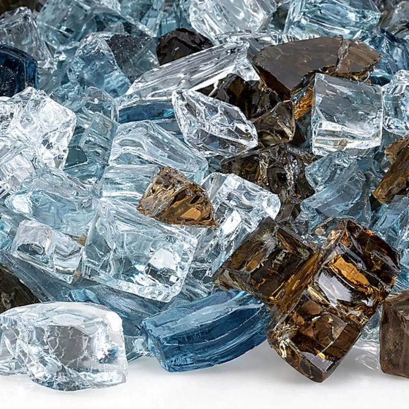 Close-up view of Bali pre-mix 1/2 inch reflective tempered fire glass showing detailed textures of aqua blue, amber, smoky brown, and clear glass pieces with smooth edges and mirror-like reflective surfaces.