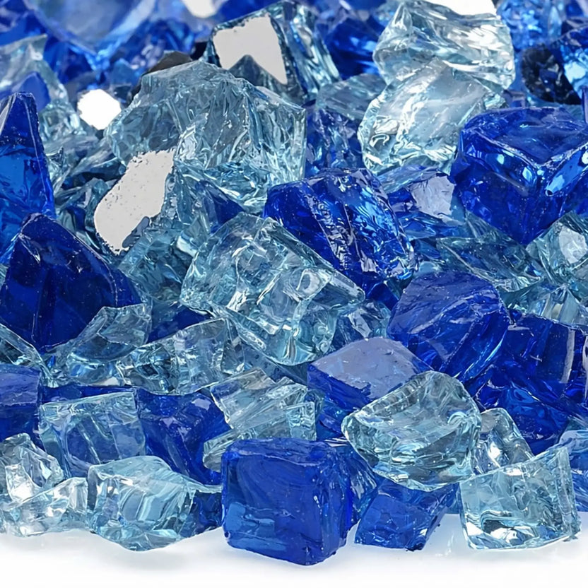 Detailed close-up of Bora Bora 1/2 inch reflective fire glass showing rich cobalt blue and pale aqua glass chunks with smooth tumbled edges and shimmering reflective coatings.