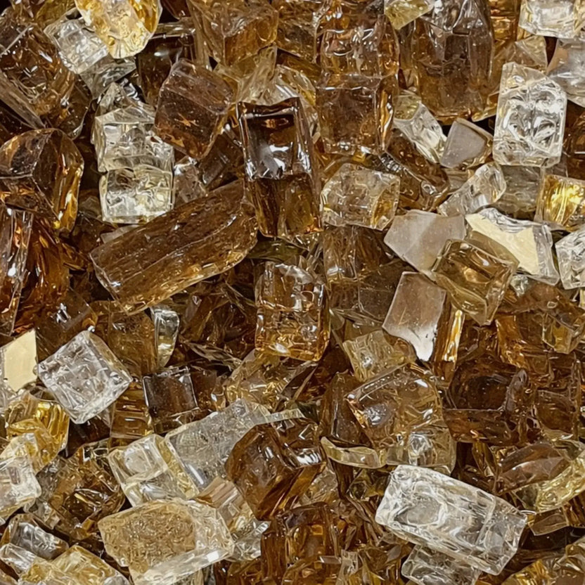 Close-up of Zion 1/2 inch reflective fire glass highlighting the blend of deep bronze, caramel amber, champagne, and clear tempered glass pieces with glossy surfaces and natural light reflections.