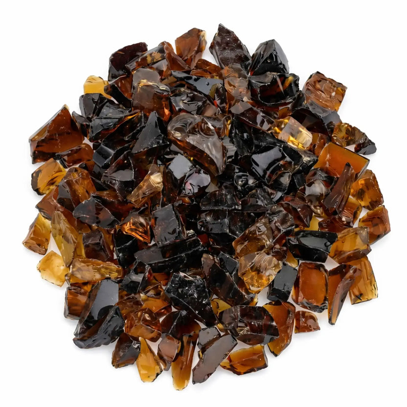 Overhead view of Auburn tempered recycled fire glass pieces in mixed amber and deep brown tones, showcasing the varied sizes and reflective surfaces of the crushed glass.