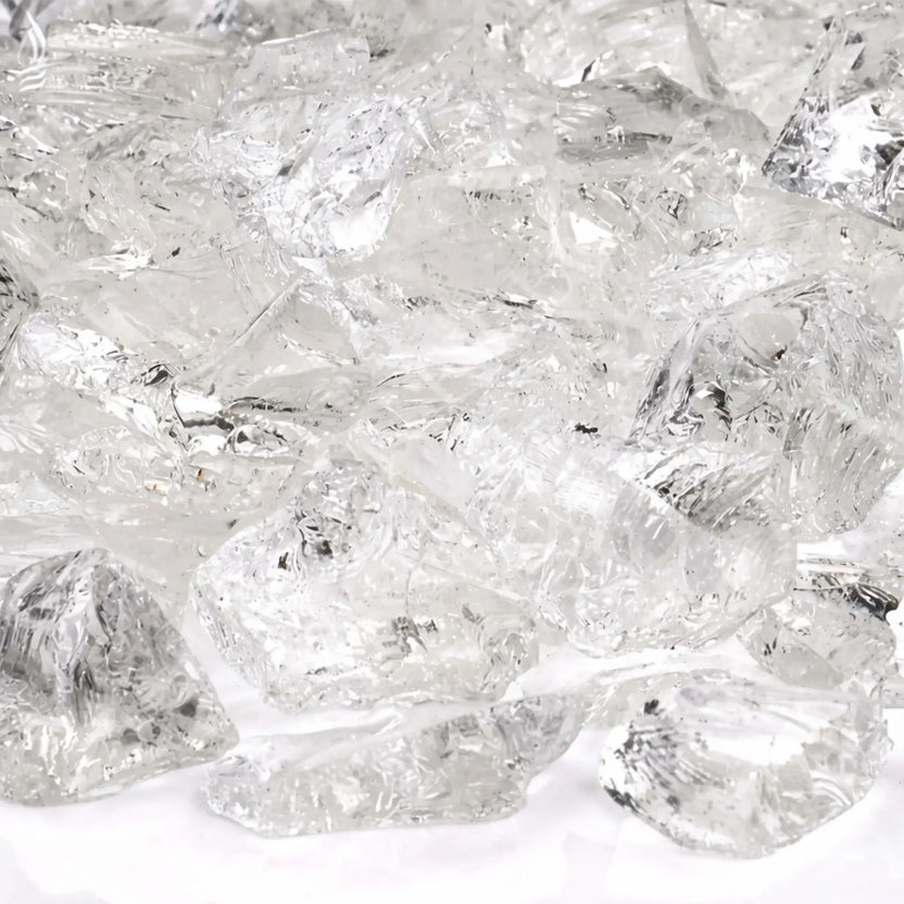 Close-up detail of Ice White fire glass highlighting smooth fractured edges, crystal-clear transparency, and subtle reflective sparkle under bright lighting.