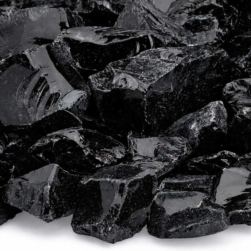 Close-up of Onyx Black fire glass highlighting smooth, tempered edges, mirror-like shine, and subtle texture variations across the dark, angular pieces.