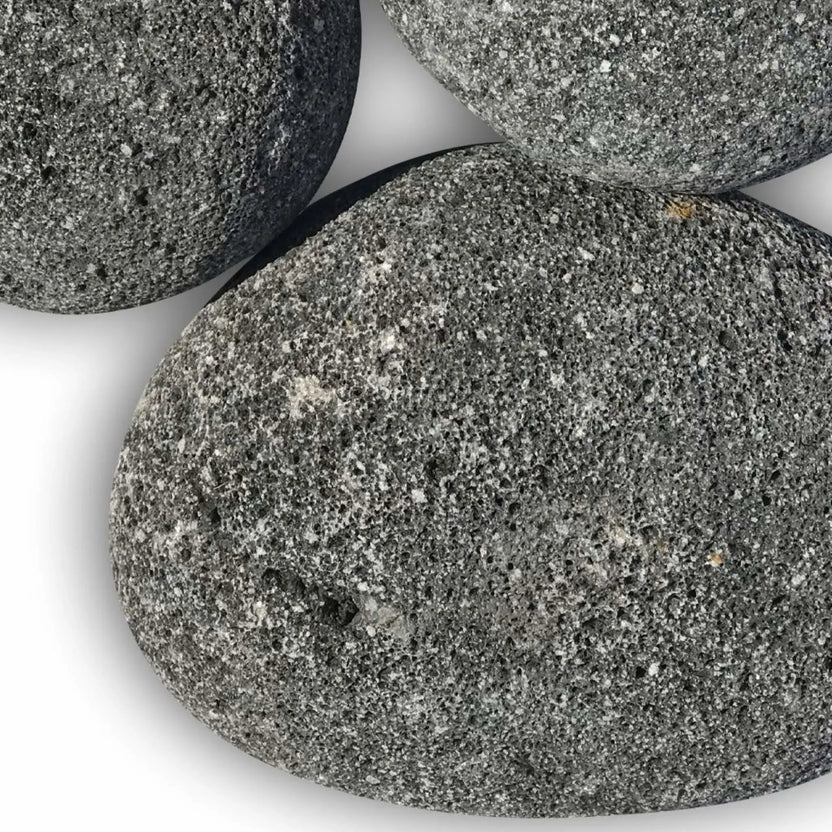 Close-up detail of an extra large lava stone from American Fire Products highlighting its rough, porous volcanic surface, natural pitting, and gray speckled texture.