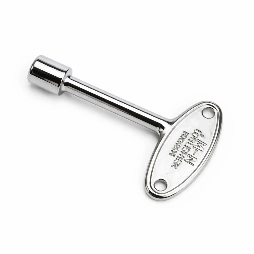 Chrome-plated fire pit valve key with reflective finish, engraved oval handle, and straight shaft, designed for operating decorative gas key valves in modern outdoor fire features.
