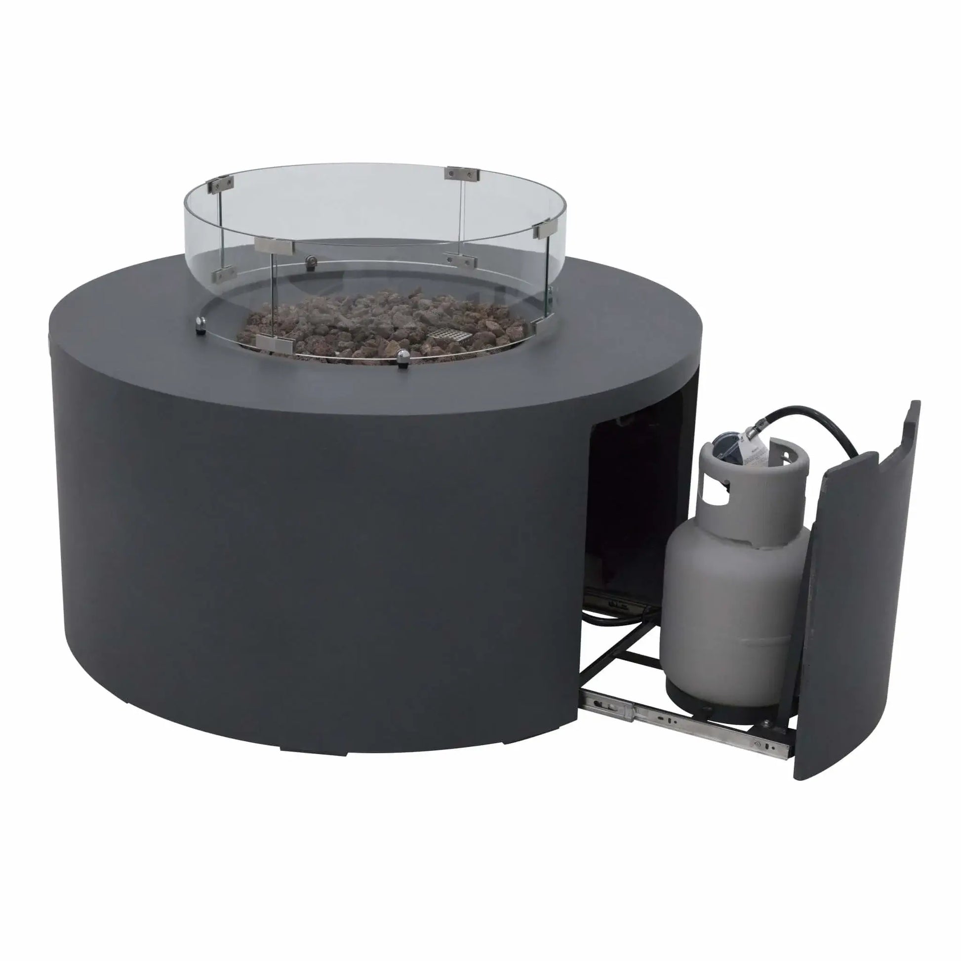 Product image of the Elementi Art of Living Pacaya Dark Grey round GFRC concrete fire pit table with the hidden propane drawer extended. The sliding compartment reveals the concealed propane tank storage system beneath the fire bowl, while the tempered glass wind guard and lava rock media remain installed above.