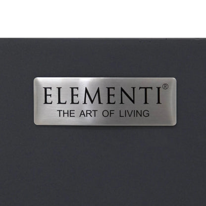 Close-up image of the brushed metal Elementi Art of Living nameplate attached to the Pacaya Dark Grey round fire pit table. The premium badge contrasts against the dark grey GFRC concrete finish, highlighting the branding and refined design details of this hidden propane outdoor fire pit table.