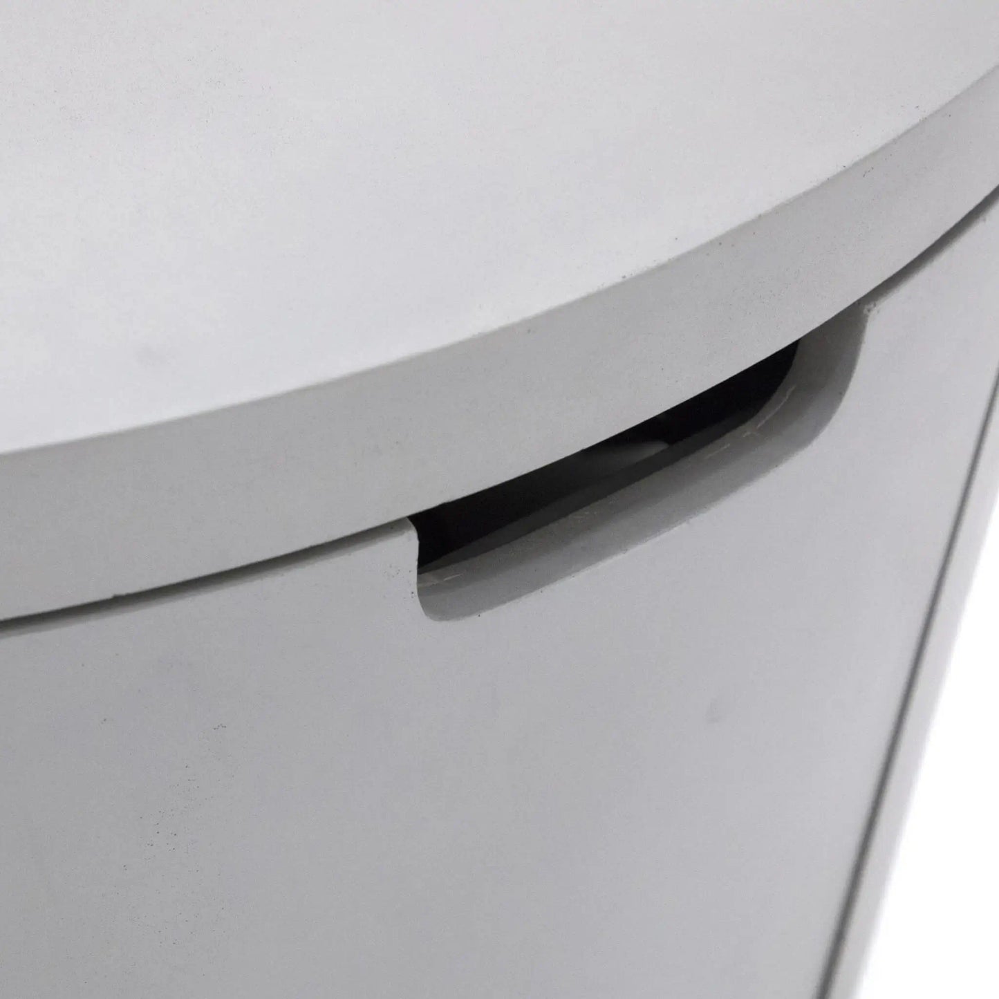 Detailed close-up of the concealed handle opening built into the Elementi Art of Living Pacaya Light Grey GFRC concrete fire pit table. The recessed grip allows convenient access to the hidden propane drawer while maintaining the table’s clean cylindrical profile, modern appearance, and seamless outdoor furniture-inspired design.