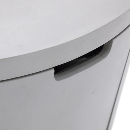 Detailed close-up of the concealed handle opening built into the Elementi Art of Living Pacaya Light Grey GFRC concrete fire pit table. The recessed grip allows convenient access to the hidden propane drawer while maintaining the table’s clean cylindrical profile, modern appearance, and seamless outdoor furniture-inspired design.