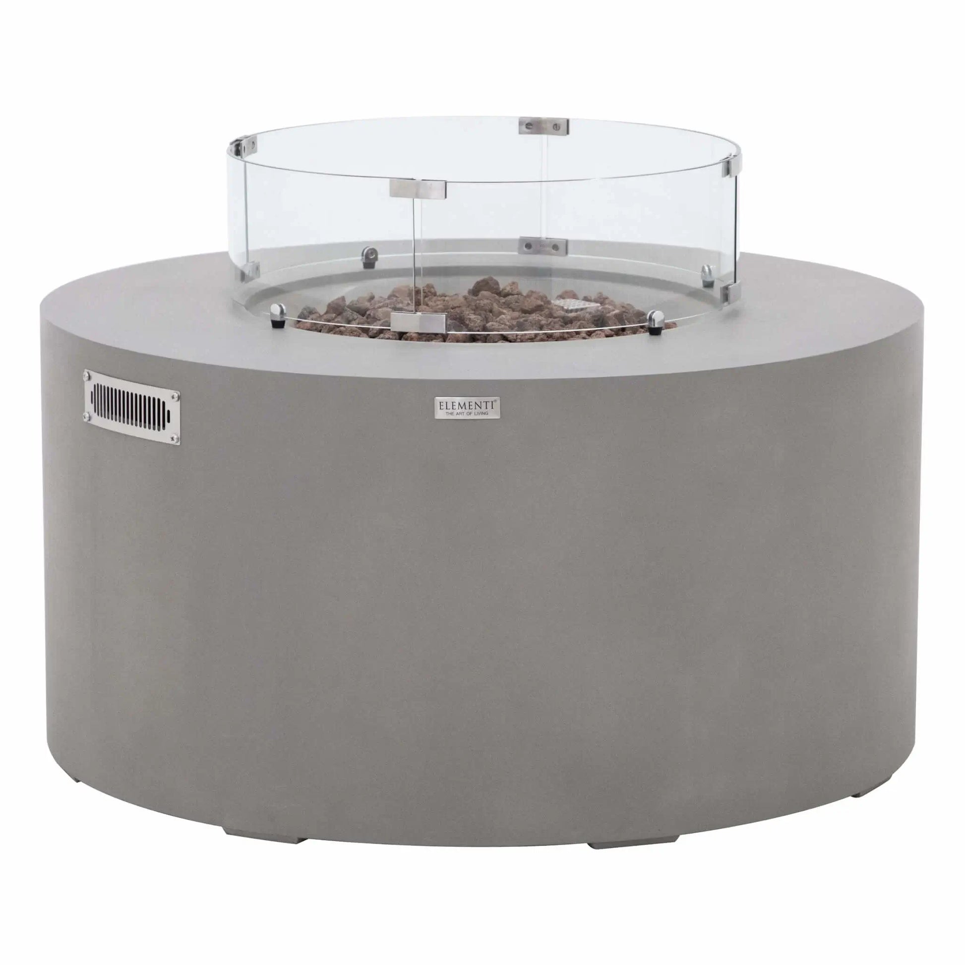 Front product view of the Elementi Art of Living Pacaya Light Grey GFRC concrete fire pit table equipped with a circular tempered glass wind guard. Displayed on a white background, the image highlights the round fire bowl, lava rock media, ventilation panel, and protective glass enclosure designed to improve flame stability while maintaining a clean modern outdoor living appearance.
