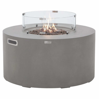 Front-facing product image of the Elementi Art of Living Pacaya Light Grey fire pit table with active flames burning above the lava rock media inside the tempered glass wind guard. The image highlights the round GFRC concrete construction, clean cylindrical profile, and warm flame display, illustrating the fire table in operation on a white background.