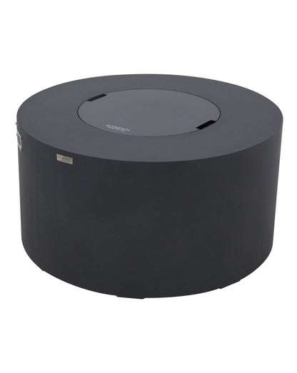 Elementi Pacaya Round Fire Pit Table in dark grey GFRC concrete, shown with its integrated burner cover. Designed for versatility, this sleek fire pit features a hidden propane tank and a removable lid, seamlessly transforming it into a functional outdoor table when not in use. Its minimalist, modern aesthetic and durable construction make it a stylish and practical addition to any patio or outdoor lounge.