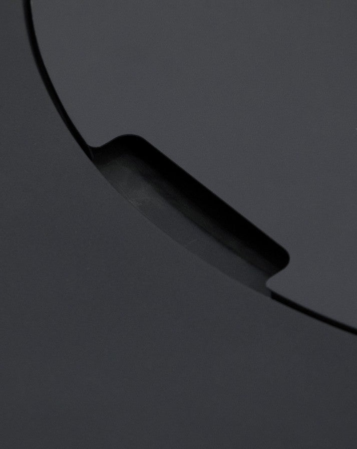 Close-up of the Elementi Pacaya Round Fire Pit Table burner cover, highlighting the precisely crafted cutout handle for easy removal. The dark grey GFRC concrete finish enhances the fire pit’s sleek, modern design, ensuring both durability and functionality. A minimalist yet sophisticated detail that elevates outdoor luxury and convenience.