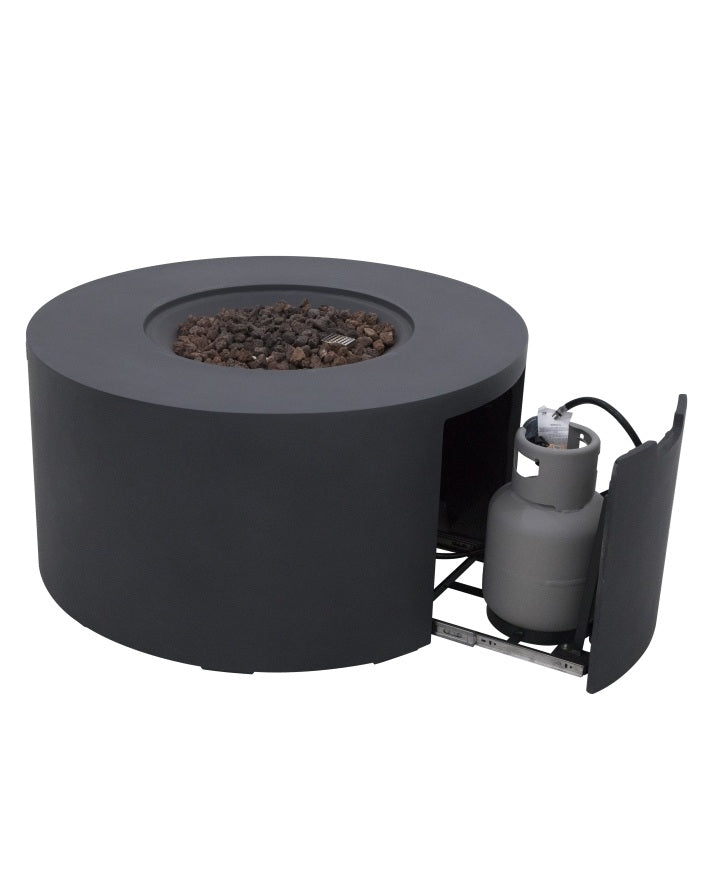 Elementi Pacaya Round Fire Pit Table in dark grey GFRC concrete, featuring a hidden propane tank compartment with a pull-out drawer. Designed for convenience and aesthetics, this modern fire pit seamlessly conceals the propane tank while providing easy access. The recessed burner with natural lava rocks enhances heat distribution, creating a stylish and functional outdoor centerpiece.