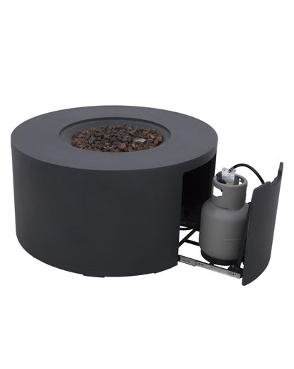 Elementi Pacaya Round Fire Pit Table in dark grey GFRC concrete, featuring a hidden propane tank compartment with a pull-out drawer. Designed for convenience and aesthetics, this modern fire pit seamlessly conceals the propane tank while providing easy access. The recessed burner with natural lava rocks enhances heat distribution, creating a stylish and functional outdoor centerpiece.