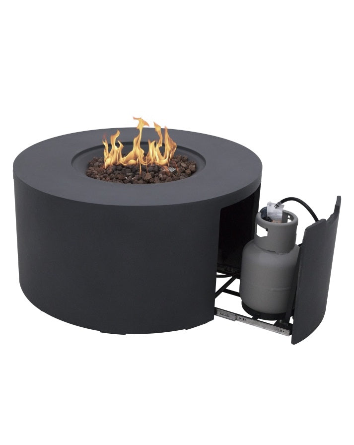 Elementi Pacaya Round Fire Pit Table in dark grey GFRC concrete, featuring a mesmerizing flame over natural lava rocks. The hidden propane tank compartment with a pull-out drawer ensures seamless integration and easy access. Designed for modern outdoor spaces, this fire pit blends functionality with sleek aesthetics, creating a warm and inviting ambiance for any patio or backyard setting.