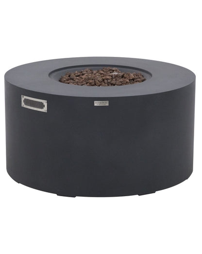 Elementi Pacaya Round Fire Pit Table in dark grey GFRC concrete, featuring a recessed burner filled with natural lava rocks. Designed with a hidden propane tank, sleek ventilation panel, and minimalist aesthetic, this modern fire pit combines durability and style, making it a perfect addition to luxury outdoor living spaces.