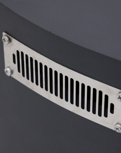Close-up of the Elementi Pacaya Round Fire Pit Table’s stainless steel ventilation panel. Strategically designed for safety and airflow, this sleek vent ensures proper propane gas circulation while seamlessly integrating into the fire pit’s dark grey GFRC concrete body. A perfect blend of functionality and modern outdoor design.