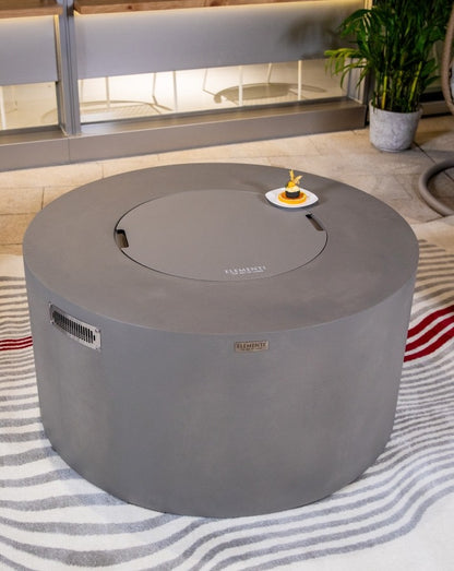 Close-up of the Elementi Pacaya Round Hidden Propane Tank Fire Pit Table in light grey GFRC concrete, featuring a sleek burner cover for a seamless transition from fire pit to functional outdoor coffee table.