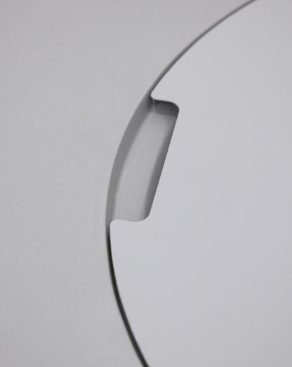 Close-up of the Elementi Pacaya Round Fire Pit Table’s burner cover, highlighting the precision-cut notch for easy removal, seamlessly integrated into the light grey GFRC concrete for a sleek and modern design.