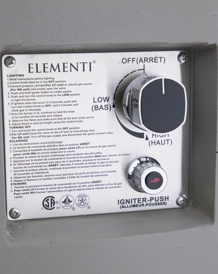 Close-up of the Elementi Pacaya Round Hidden Propane Tank Fire Pit Table's control panel, showcasing an easy-to-use ignition system with adjustable flame settings. Designed for convenience and safety, this light grey GFRC concrete fire pit features a push-button igniter and smooth dial operation for effortless ambiance control.