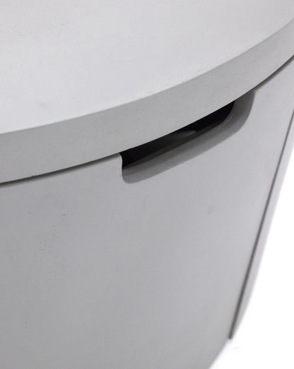 Close-up of the Elementi Pacaya Round Hidden Propane Tank Fire Pit Table’s discreet pull-out drawer, seamlessly integrated into the light grey GFRC concrete design for convenient and stylish propane tank storage.