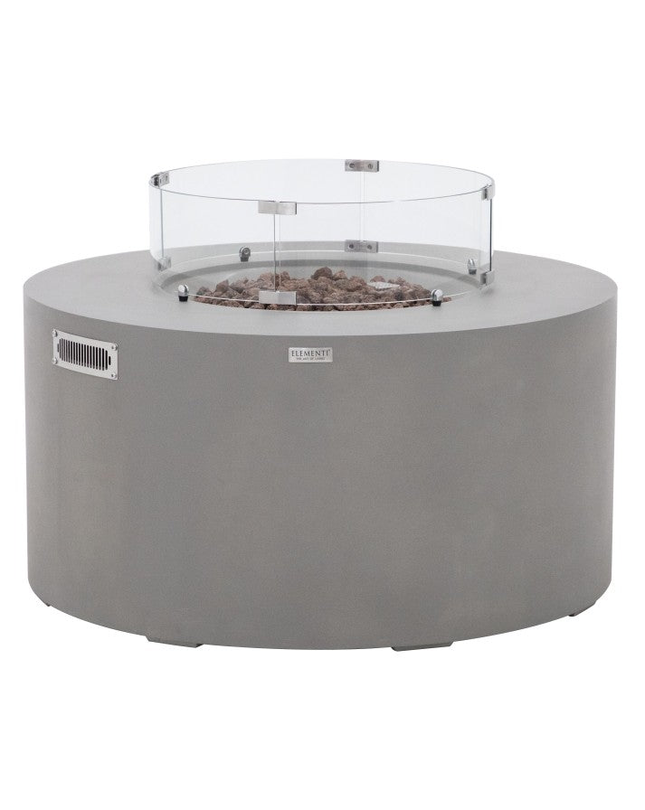 Elementi Pacaya Round Hidden Propane Tank Fire Pit Table in light grey GFRC concrete, featuring natural lava rock media and a sleek glass wind guard. This modern fire feature offers a sophisticated outdoor centerpiece, combining durability, functionality, and style for cozy gatherings.