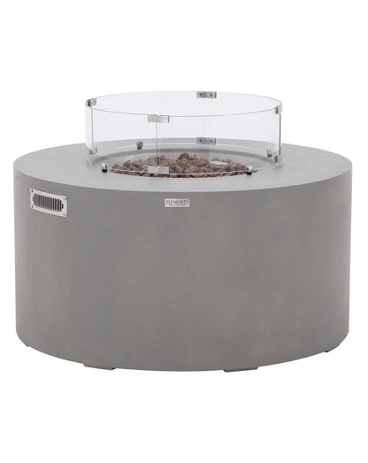 Elementi Pacaya Round Hidden Propane Tank Fire Pit Table in light grey GFRC concrete, featuring natural lava rock media and a sleek glass wind guard. This modern fire feature offers a sophisticated outdoor centerpiece, combining durability, functionality, and style for cozy gatherings.