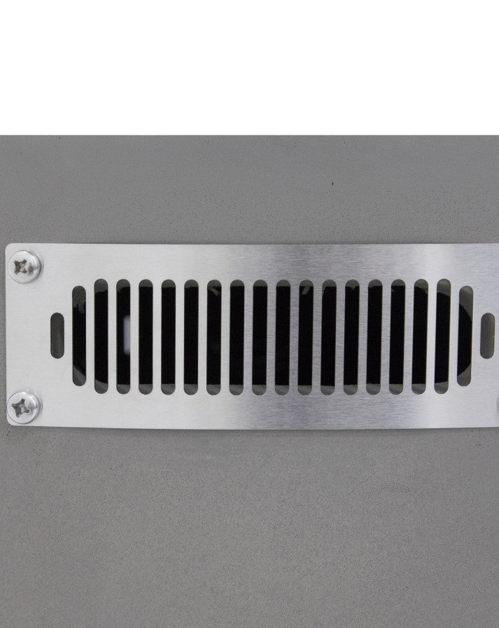 Close-up of the Elementi Pacaya Round Hidden Propane Tank Fire Pit Table’s stainless steel side vent, seamlessly integrated into the light grey GFRC concrete structure. This ventilation system ensures optimal airflow and safety while maintaining the fire pit’s sleek, modern design.