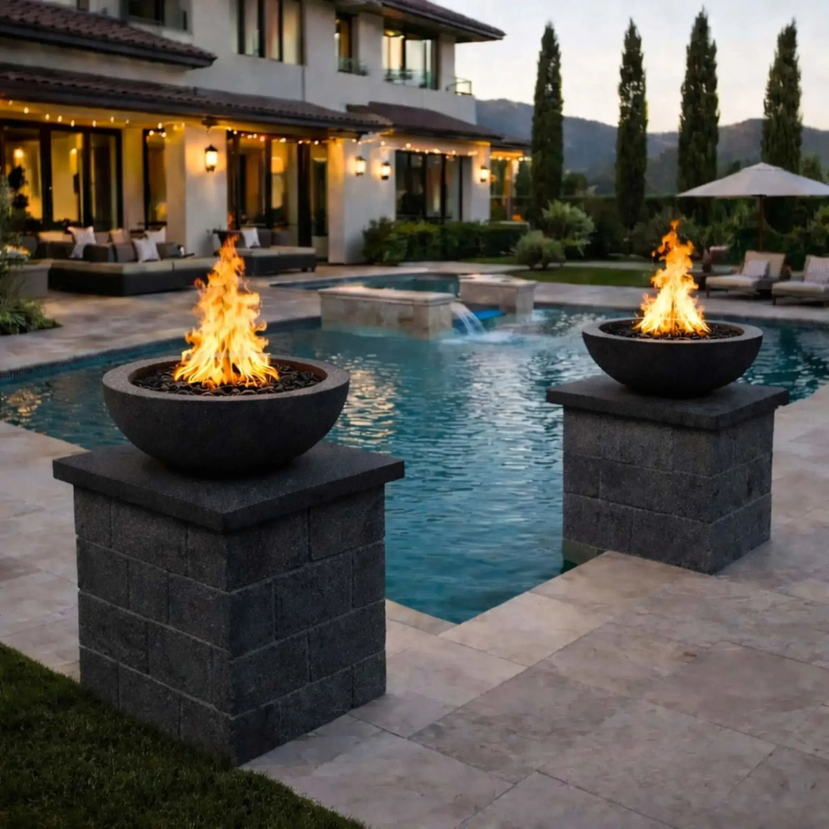 Black Flame Havens round fire bowls burning with bold, tall flames beside a contemporary pool, showcasing a dramatic poolside fire feature installation that enhances a high-end outdoor entertainment area.