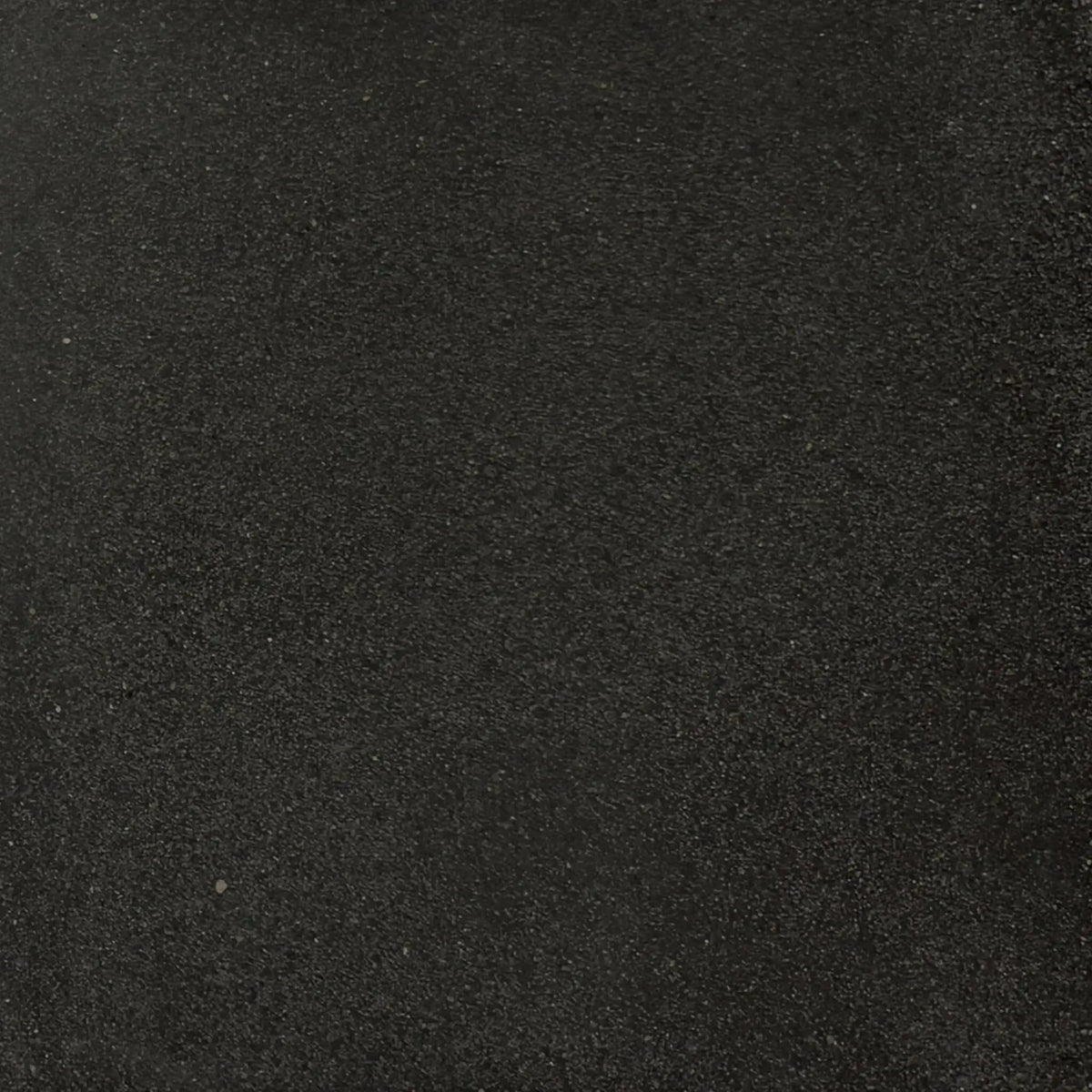 Full-size black GFRC concrete finish sample by Flame Havens, highlighting the rich dark tone and subtle aggregate texture characteristic of durable glass fiber reinforced concrete fire features.