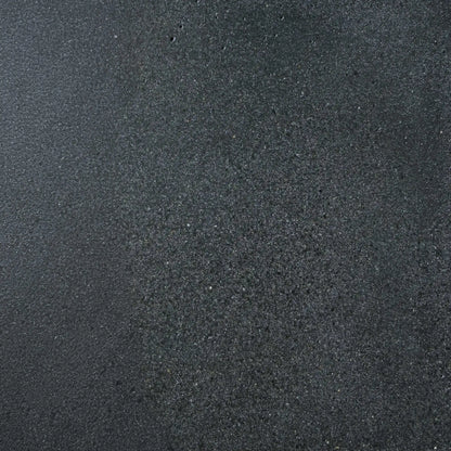 Close-up texture sample of Flame Havens Concrete GFRC Glass Fiber Reinforced Concrete Swatch Black V4 finish. The image showcases a dark charcoal black concrete surface with subtle tonal variation, fine aggregate detailing, and a lightly textured matte appearance designed for modern outdoor fire pit tables, concrete fire features, and contemporary patio furniture applications.