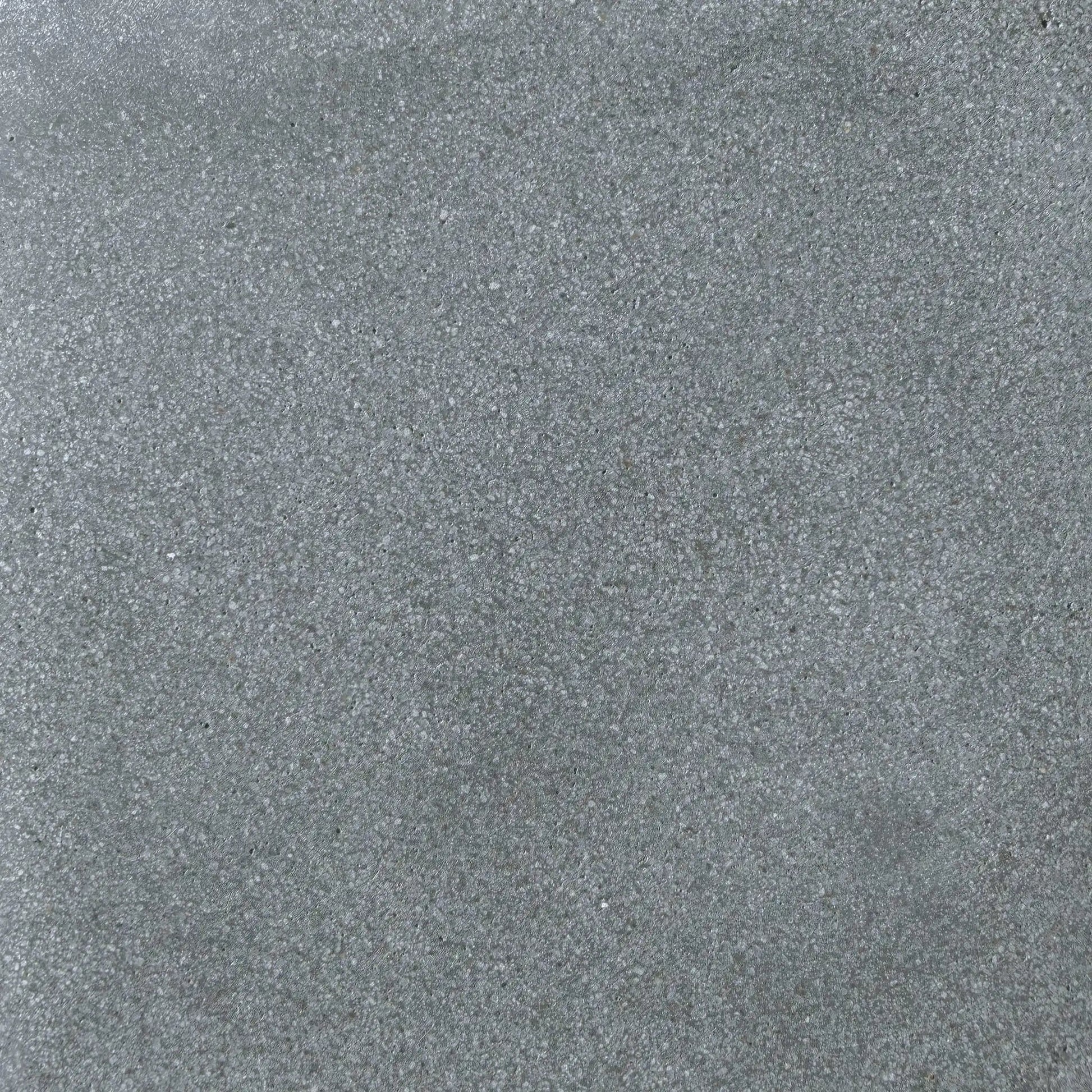 Detailed surface texture of Flame Havens Concrete GFRC Glass Fiber Reinforced Concrete Swatch Gray V4 finish. This close-up image highlights the smooth gray concrete coloration with fine speckled aggregate, soft tonal movement, and durable matte texture commonly used on GFRC concrete fire pits, outdoor fire tables, and modern patio heating products.