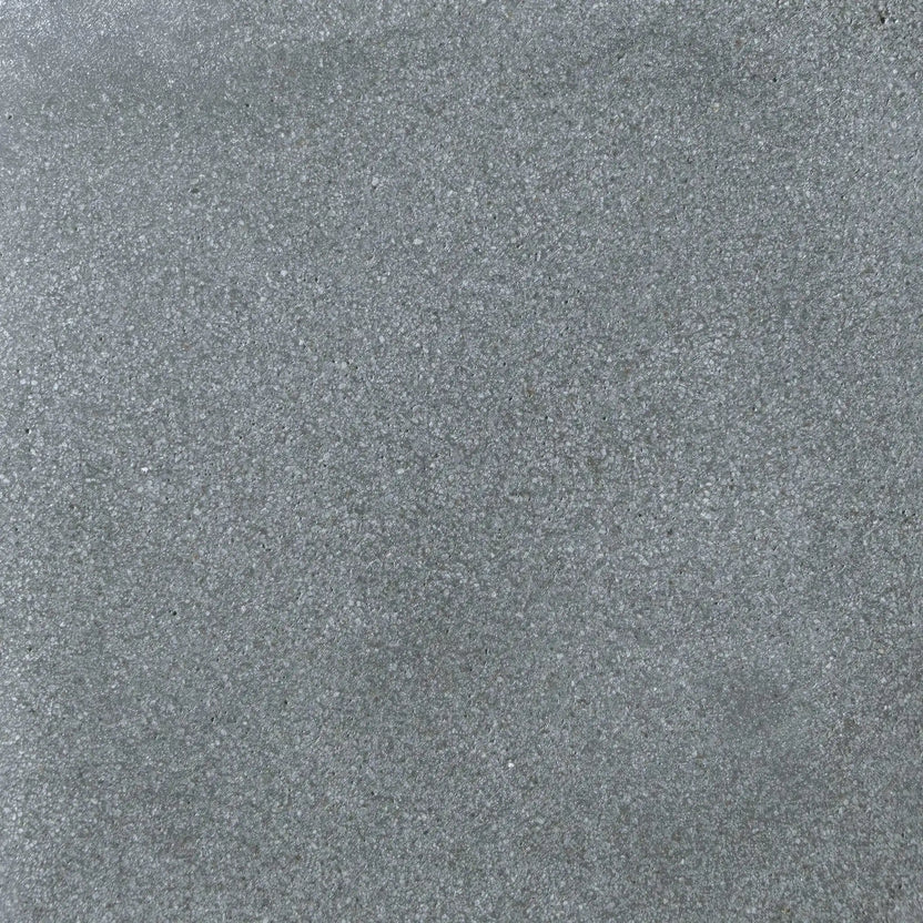 Detailed surface texture of Flame Havens Concrete GFRC Glass Fiber Reinforced Concrete Swatch Gray V4 finish. This close-up image highlights the smooth gray concrete coloration with fine speckled aggregate, soft tonal movement, and durable matte texture commonly used on GFRC concrete fire pits, outdoor fire tables, and modern patio heating products.