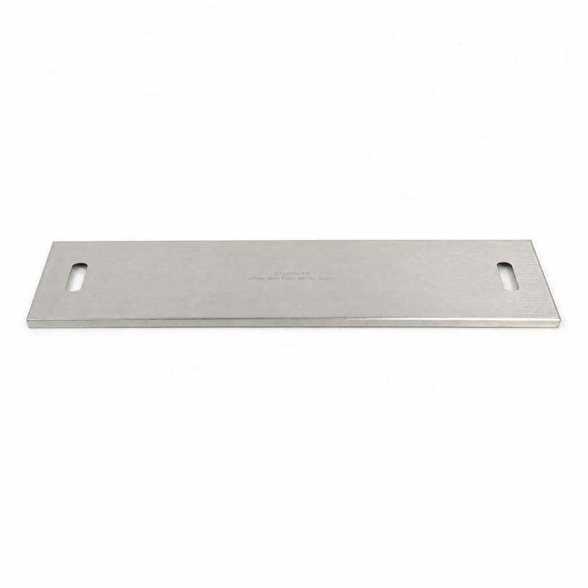 Flame Havens Refuge Series 33 x 11-inch rectangular stainless steel burner cover shown in full against a white background. The brushed metal cover features a slim, low-profile design, rounded rectangular handle openings at both ends, finished edges, and a centered caution message indicating the surface may be hot after use.