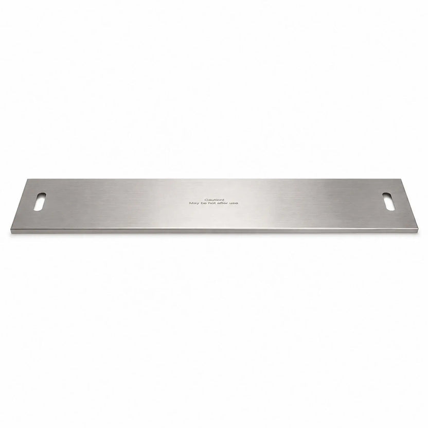 Full product view of the Flame Havens Refuge Series 45 x 11-inch rectangular stainless steel burner cover on a white background. The long, low-profile cover features a brushed metal finish, rounded rectangular handle openings at both ends, folded edges, and a centered “Caution! May be hot after use” safety message.