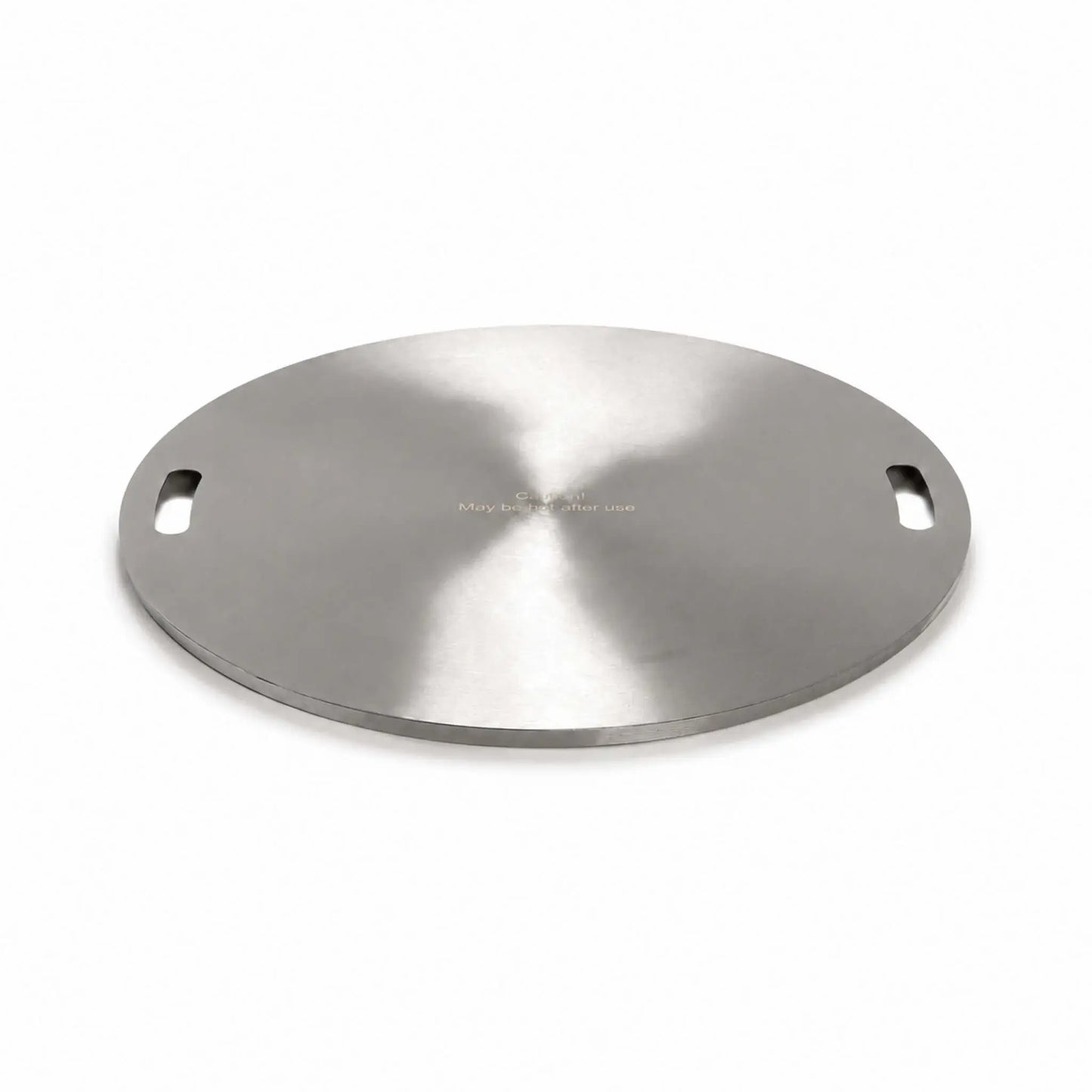 Angled product view of the Flame Havens Refuge Series 24-inch round stainless steel burner cover on a white background. The circular cover has a brushed finish, two recessed carrying handles positioned on opposite sides, a low-profile finished edge, and a centered warning that it may be hot after use.