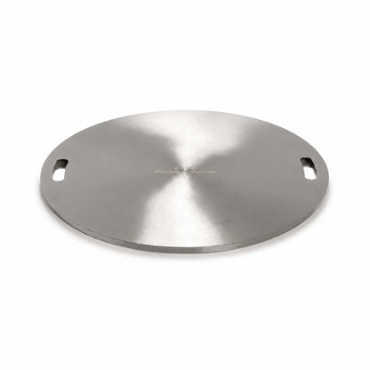 Angled product view of the Flame Havens Refuge Series 24-inch round stainless steel burner cover on a white background. The circular cover has a brushed finish, two recessed carrying handles positioned on opposite sides, a low-profile finished edge, and a centered warning that it may be hot after use.
