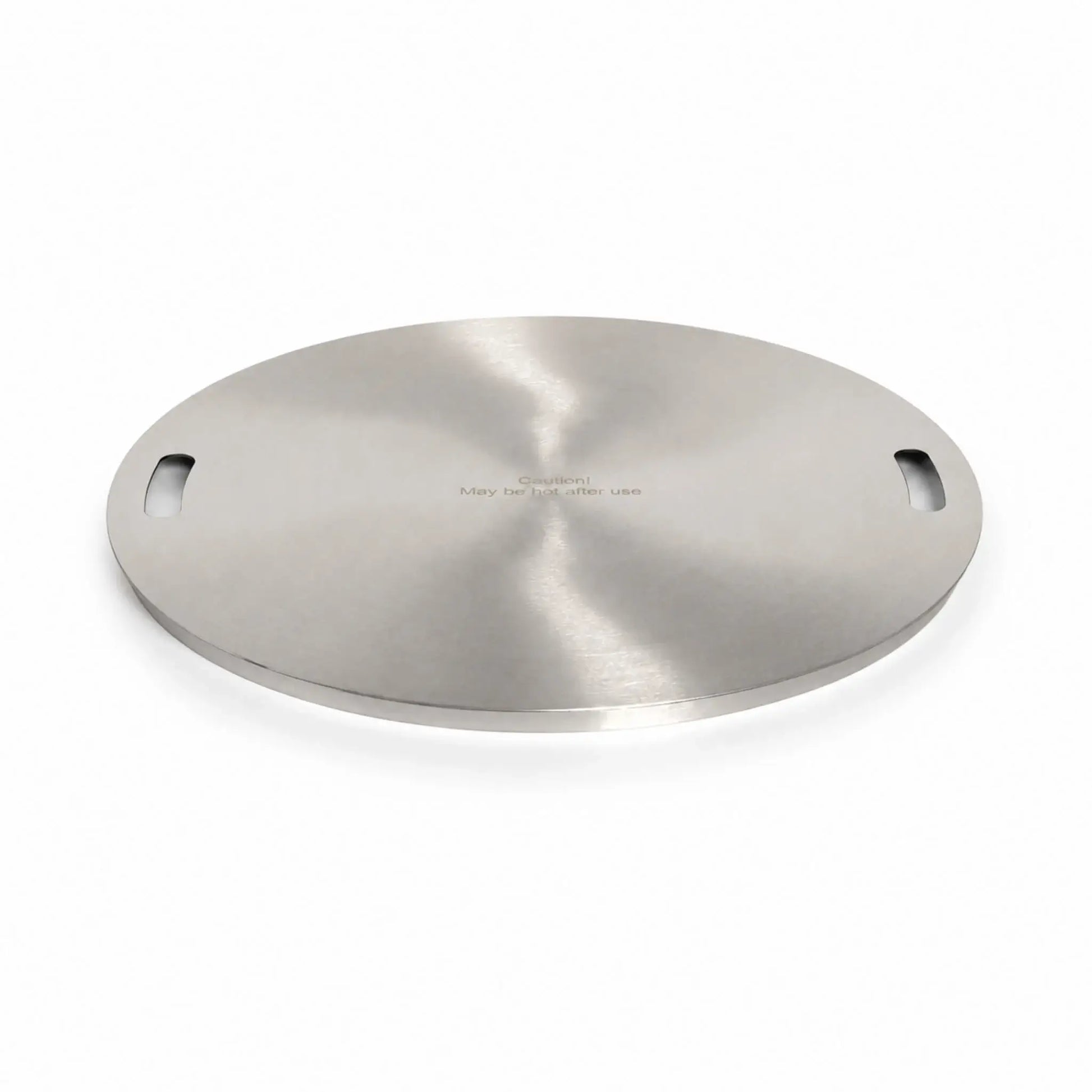 Main view of the Flame Havens Refuge Series 24-inch round stainless steel burner cover. Shown at a low angle on a white background, the circular accessory features a reflective brushed finish, two integrated handle openings, a slim raised edge, and the engraved message, “Caution! May be hot after use.”