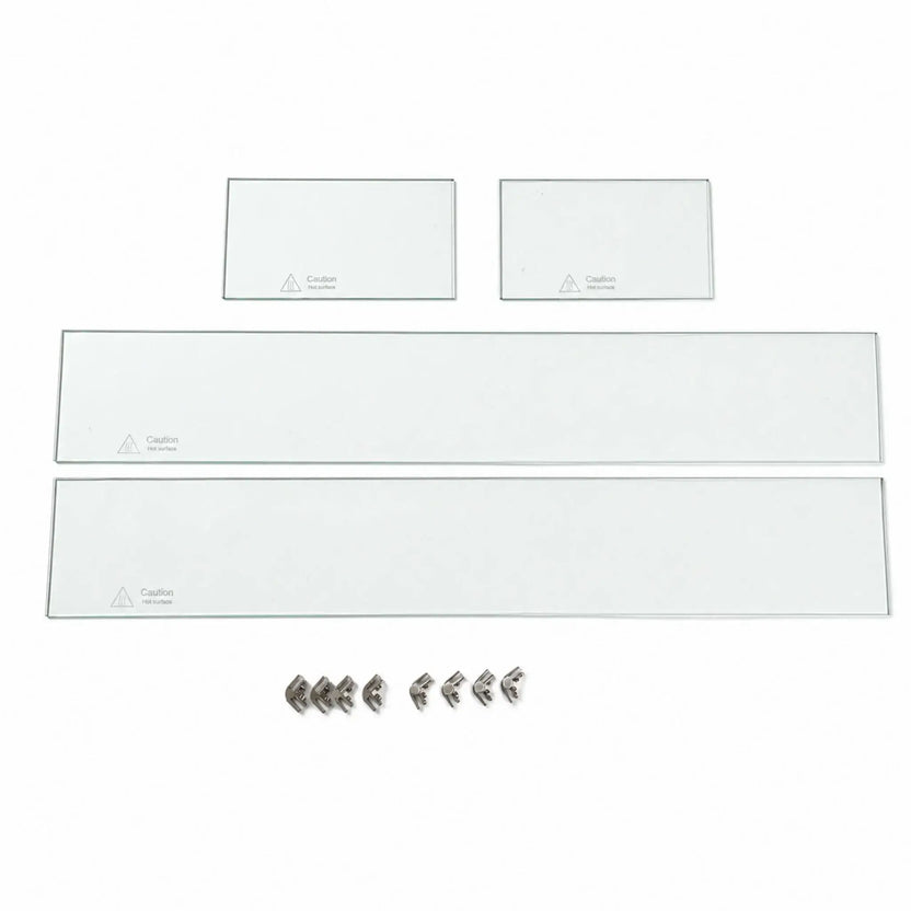 Disassembled Flame Havens Refuge Series 36 x 14 x 7-inch rectangular tempered glass wind guard shield arranged on a white background. The set includes two long and two short clear glass panels with “Caution Hot surface” markings, plus eight silver corner hardware pieces for connecting and supporting the panels.