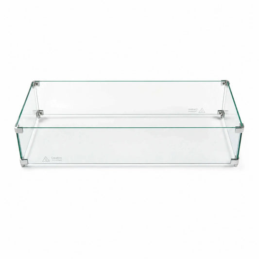 Fully assembled Flame Havens Refuge Series 36 x 14 x 7-inch rectangular tempered glass wind guard shield shown against a white background. Four clear glass panels form a low-profile enclosure joined by silver corner brackets and support feet, with visible “Caution Hot surface” markings along the lower edges.