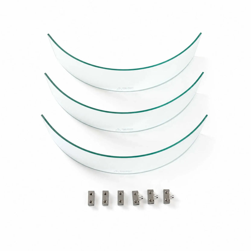 Disassembled Flame Havens Refuge Series tempered glass wind guard shield measuring 28 inches round by 7 inches tall. Three curved clear glass panels with green-tinted edges and hot-surface warnings are arranged above six silver metal clamps and support pieces on a white background.
