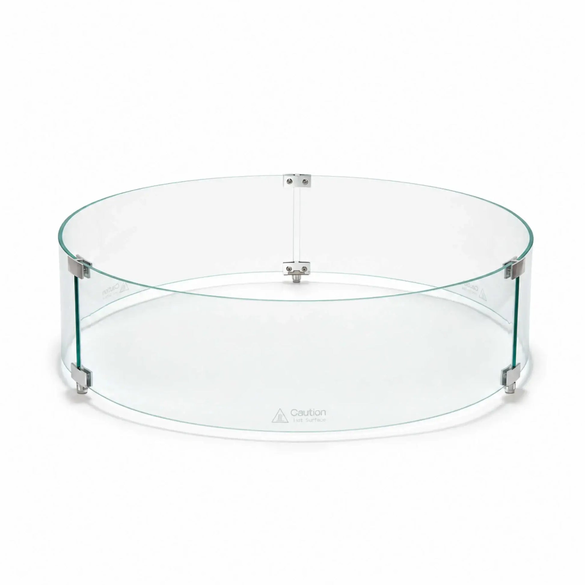 Front main view of the Flame Havens Refuge Series 28-inch round by 7-inch-tall tempered glass wind guard shield. The clear circular enclosure features green-tinted glass edges, silver panel connectors, three raised support feet, and visible hot-surface caution markings along the lower panels.