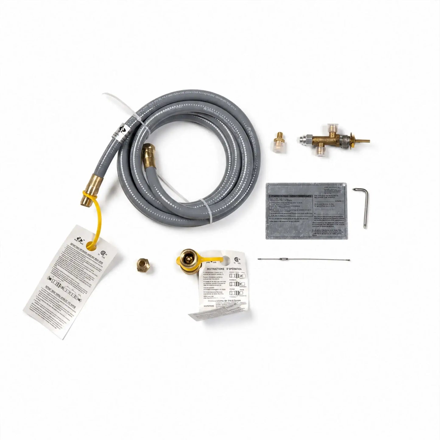 Flame Havens Refuge Series fire pit conversion kit for changing a propane gas unit to natural gas. Arranged on a white background, the kit includes a coiled gray quick-connect gas hose, brass control valve assembly, orifice and connector fittings, hex key, slender metal component, operating instructions, safety tags, and specification label.