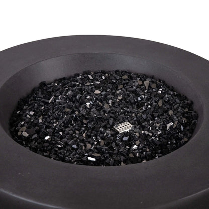 Close-up view of the Flame Havens Refuge Series 36-inch Round Natural Gas GFRC Concrete Fire Pit in Black, showcasing the premium black reflective fire glass evenly covering the stainless steel burner system. The image highlights the smooth concrete finish, generous burner opening, and elegant round design, demonstrating the upscale appearance of the Black Fire Glass media before the fire pit is ignited.