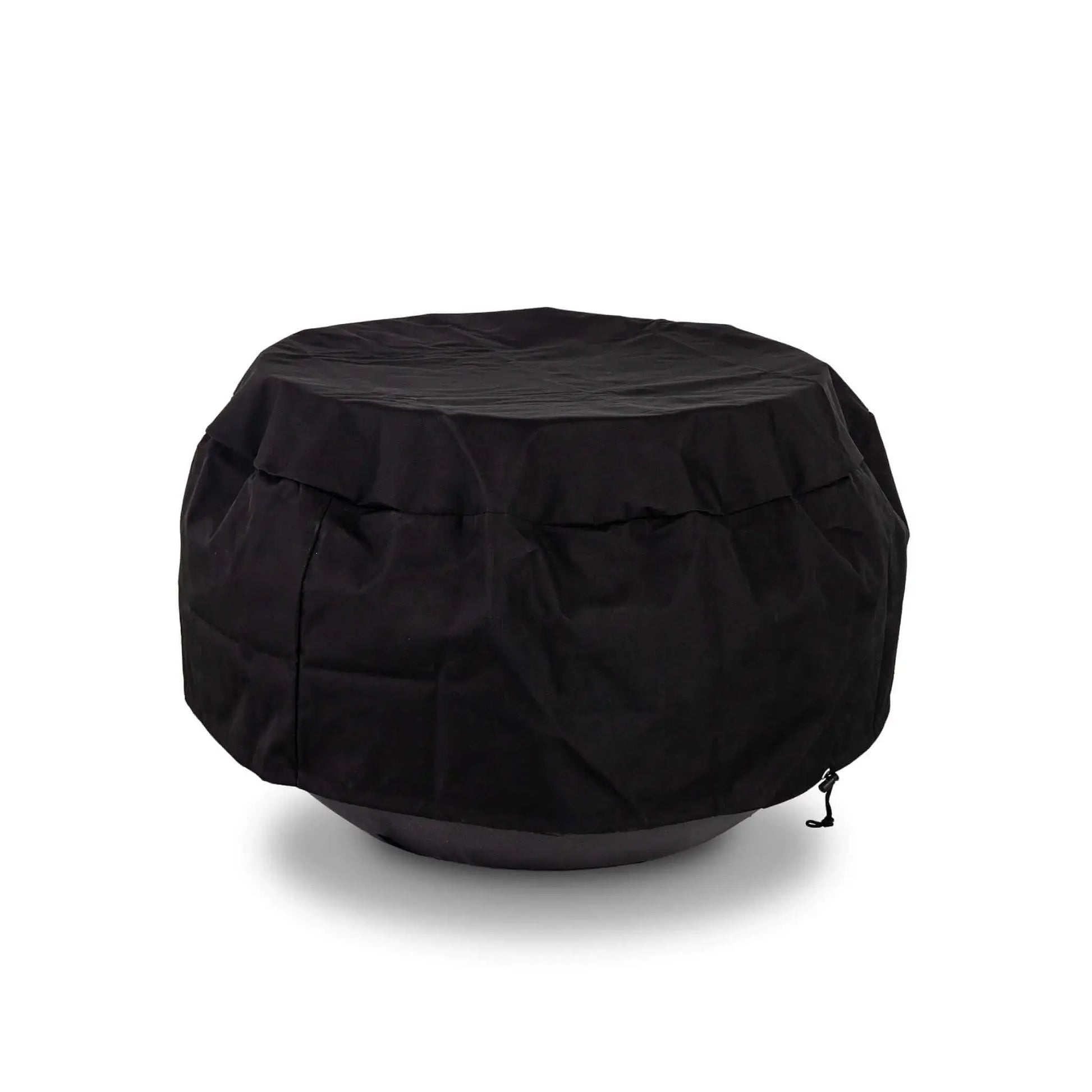 The Flame Havens Refuge Series 36-inch Round Natural Gas GFRC Concrete Fire Pit in Black protected by the black canvas fabric cover while installed over the optional tempered glass wind guard. The fitted weather-resistant cover accommodates the wind guard, providing year-round protection for premium outdoor fire pit accessories without requiring removal.