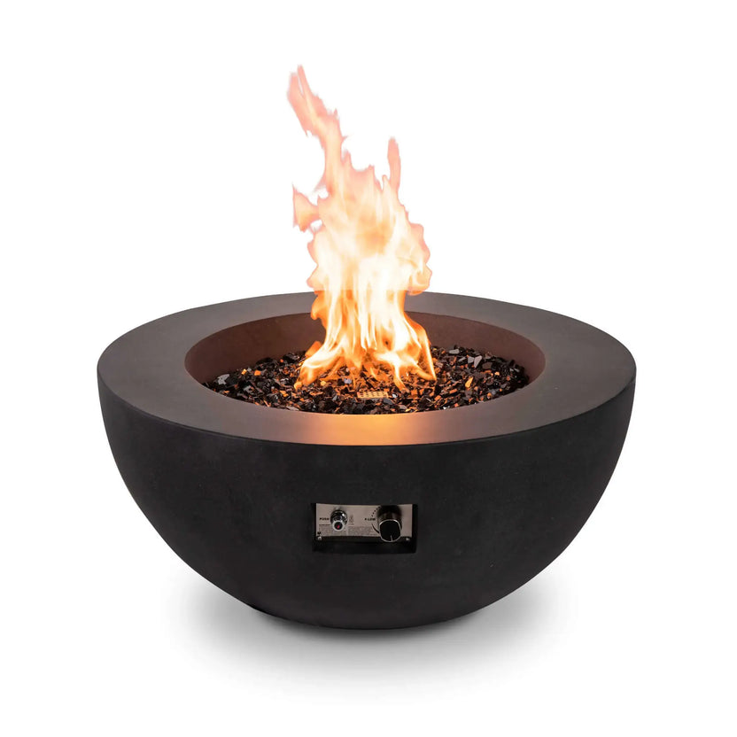 Front product image of the Flame Havens Refuge Series 36-inch Round Natural Gas GFRC Concrete Fire Pit in Black burning over tempered black reflective fire glass. The recessed stainless steel CSA-certified ignition control panel remains visible, highlighting both the premium flame presentation and the convenient front-mounted ignition and flame adjustment controls.