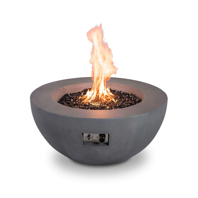 Front-facing product image of the Flame Havens Refuge Series 36-inch Round Natural Gas GFRC Concrete Fire Pit in Gray featuring black tempered reflective fire glass and an active flame. The recessed stainless steel ignition controls are visible on the front, combining convenient operation with a sleek, contemporary GFRC concrete design.